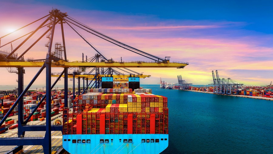 Panorama of cargo ship and cargo container in harbor.